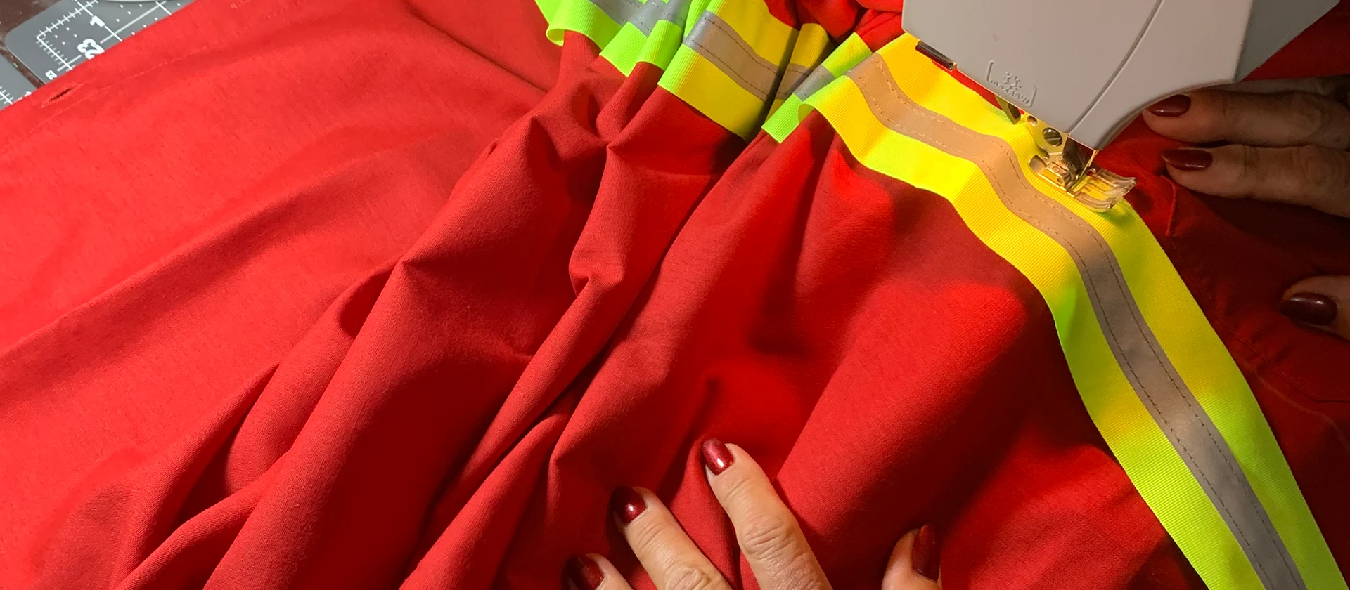 Custom hi-vis workwear being handmade with reflective tape