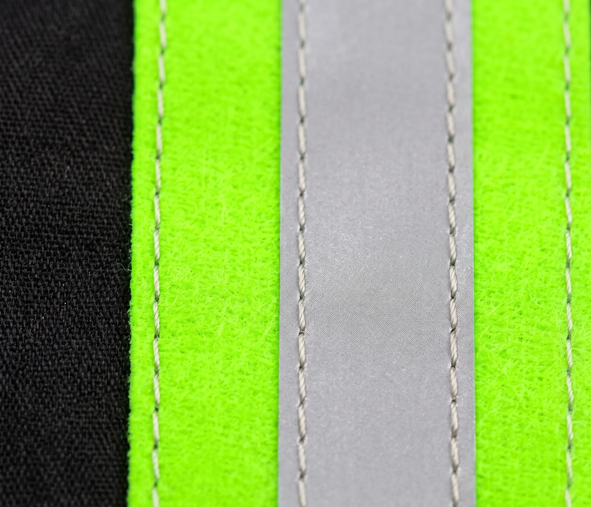 Macro close up of heavy duty dual stitched sewn on reflective tape on a Liliana Hi Vis work shirt